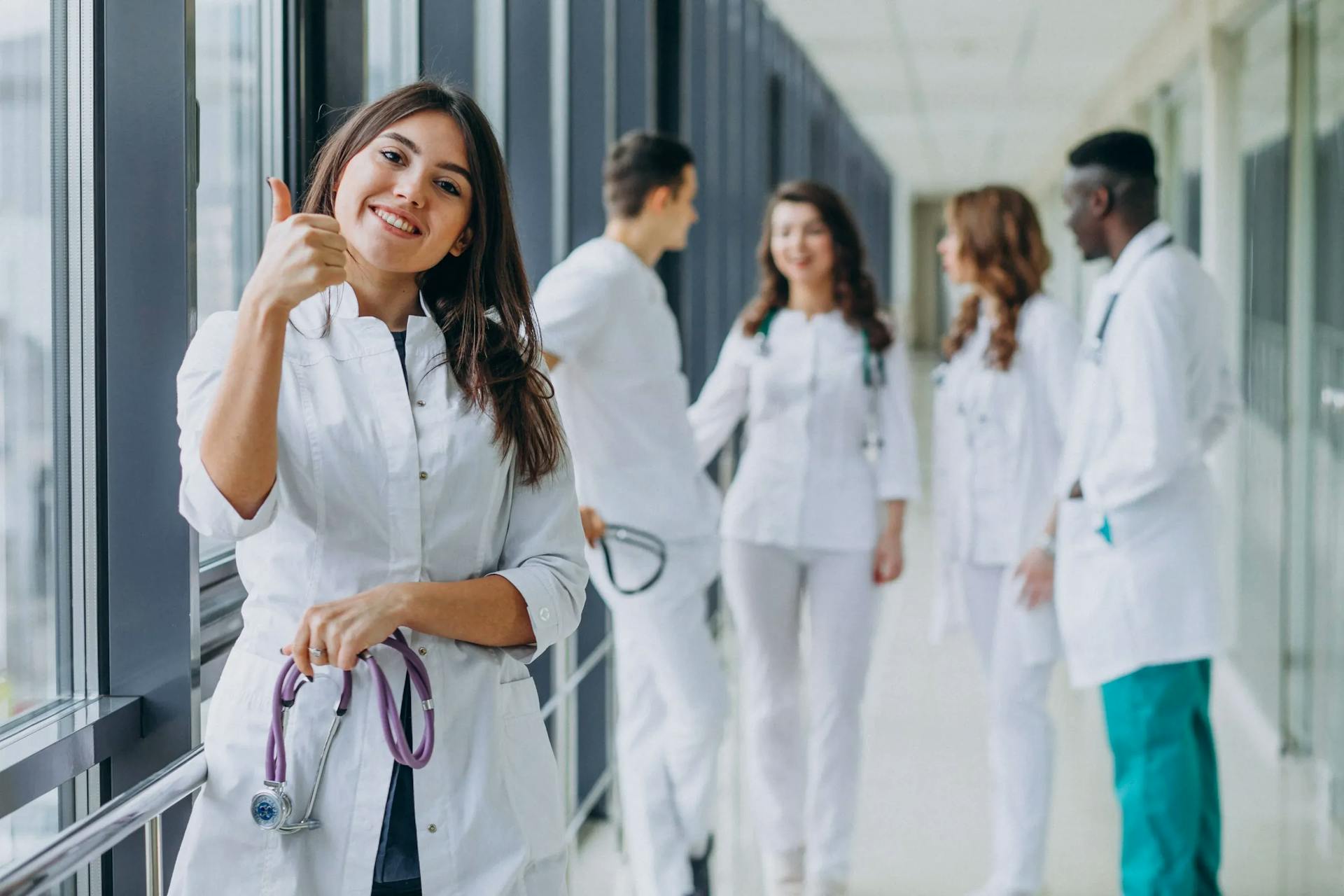 https://strapiassetsprod.s3.amazonaws.com/young_female_doctor_with_thumbs_up_gesture_standing_corridor_hospital_11zon_85b1185007.webp